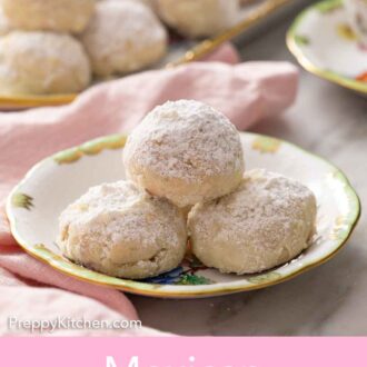 Pinterest graphic of a plate with three Mexican wedding cookies with a platter more in the background.