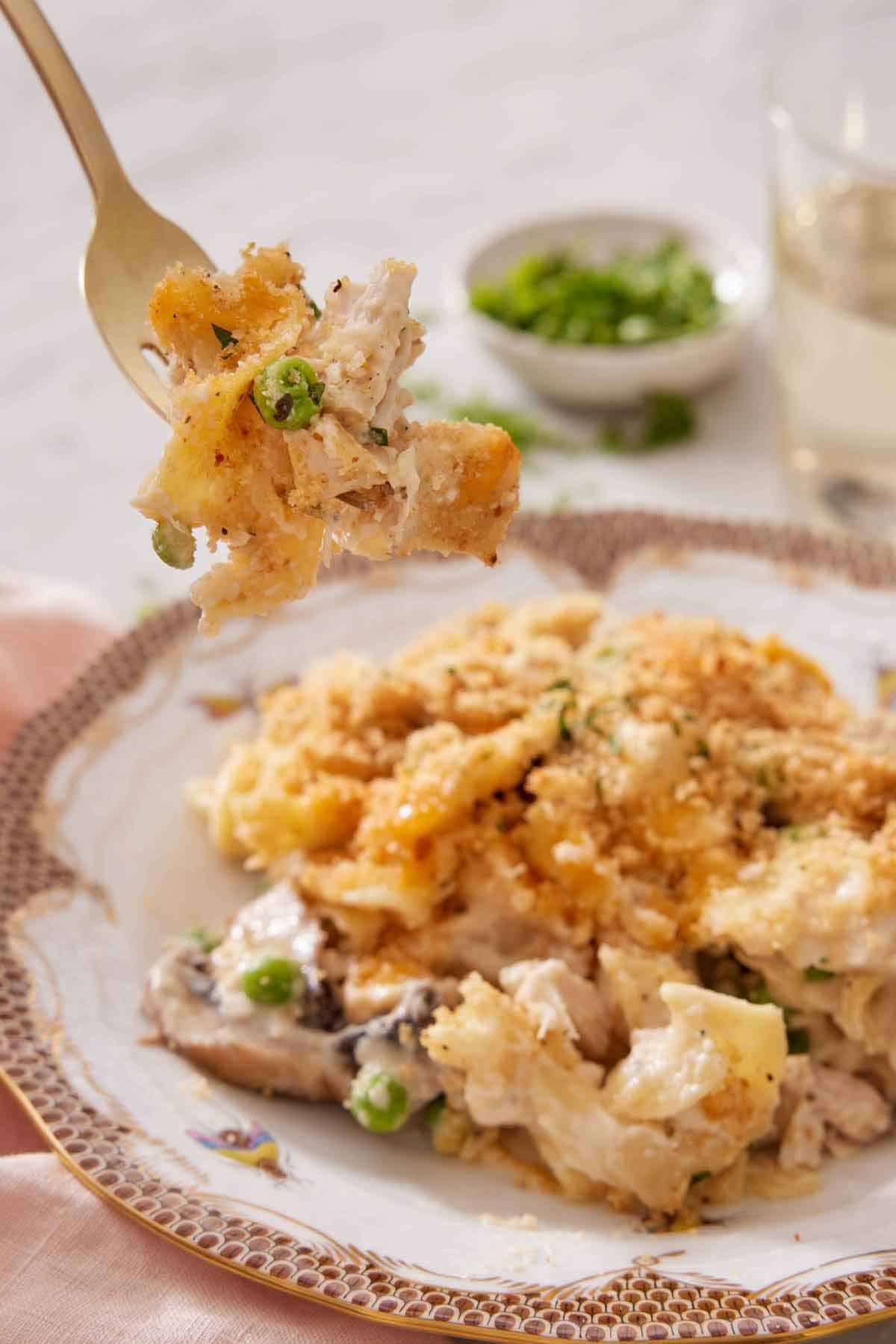 A forkful of turkey casserole lifted from the plate.