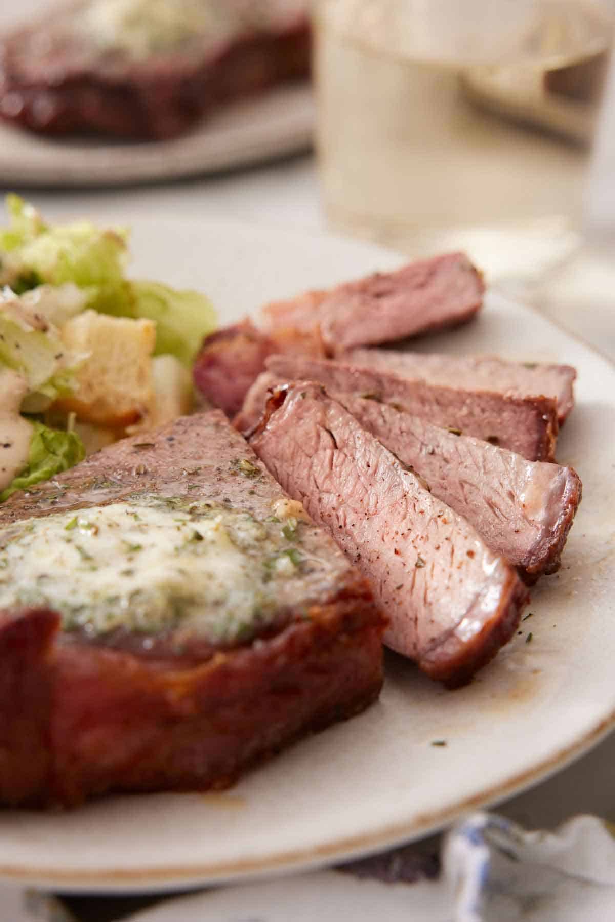 A close up view of air fryer steak sliced, showing the interior of the slices.