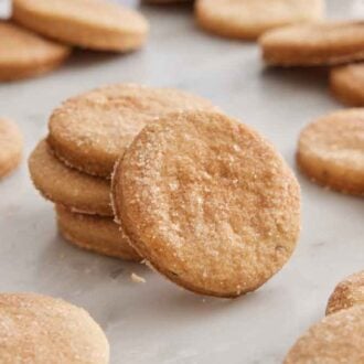 Multiple biscochitos with a stack in the middle with one leaning up against it.