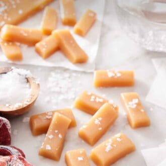 Pinterest graphic of multiple caramels with additional in the background, topped with sea salt.