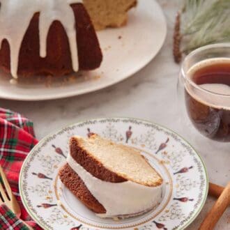 Pinterest graphic of a slice of eggnog cake with the rest of the cake in the background.