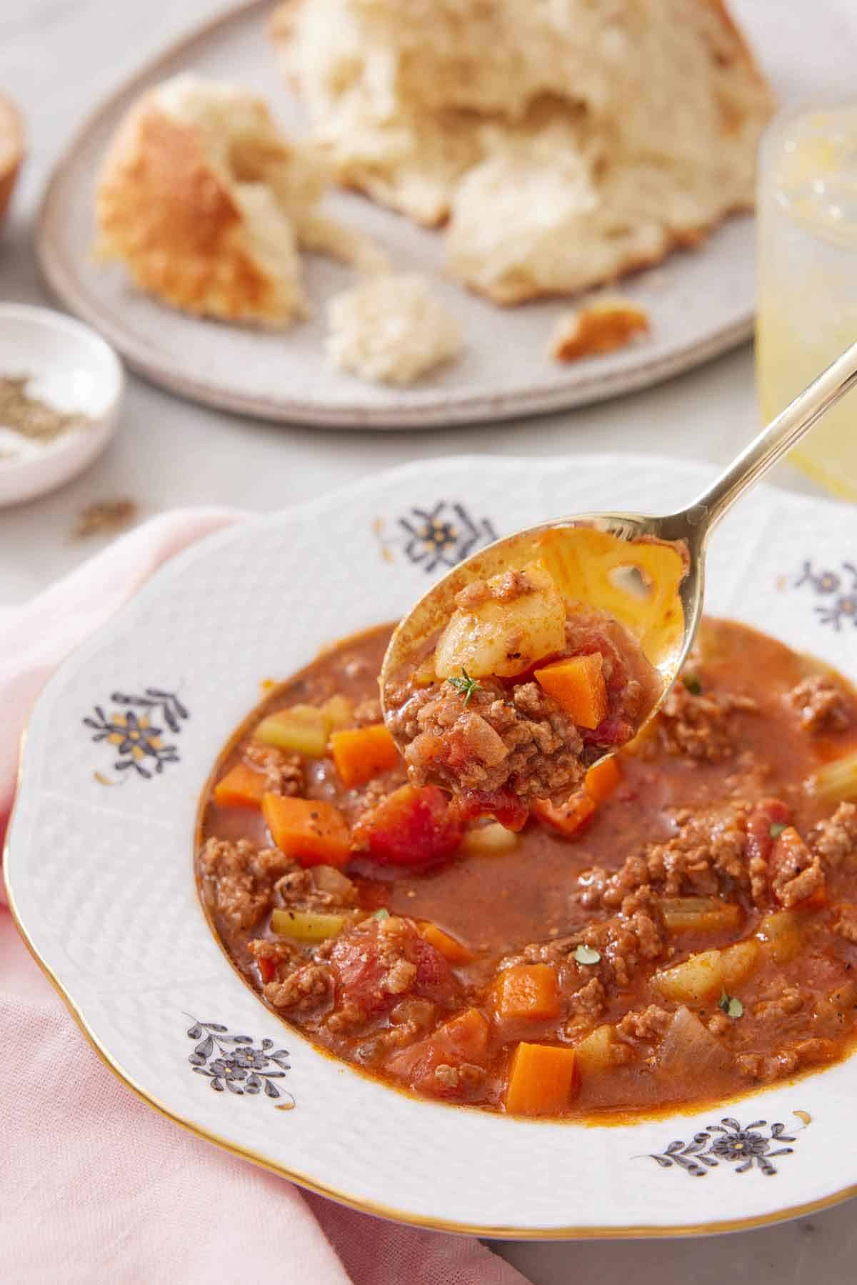 A spoonful of hamburger soup lifted from the bowl.