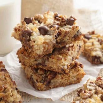 A stack of three magic cookie bars surrounded by more cut bars.