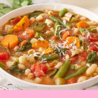 Pinterest graphic of parmesan cheese grated over a bowl of minestrone soup.