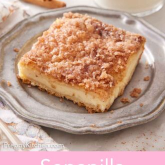 Pinterest graphic of a plate with a slice of sopapilla cheesecake with a glass of milk in the background.