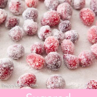 Pinterest graphic of sugared cranberries on a lined sheet pan.