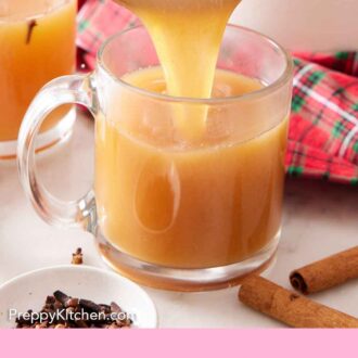 Pinterest graphic of wassail poured into a glass mug.