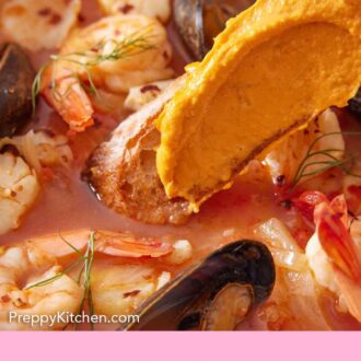 Pinterest graphic of bread with rouille dipped into a bowl of bouillabaisse.