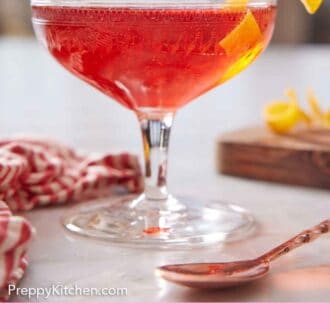 Pinterest graphic of a glass of boulevardier with an orange twist garnish on the rim.