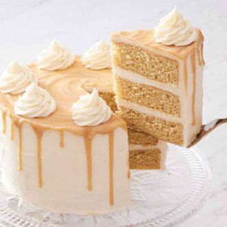 A slice of butterscotch cake lifted from the rest of the cake.
