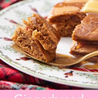 Pinterest graphic of fork with a bite of gingerbread pancakes with the rest of the pancakes in the back.