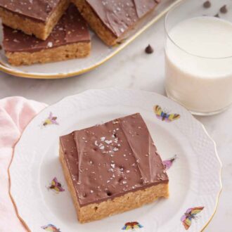 Pinterest graphic of a plate with a Special K bar with a glass of milk and platter of more bars in the background.