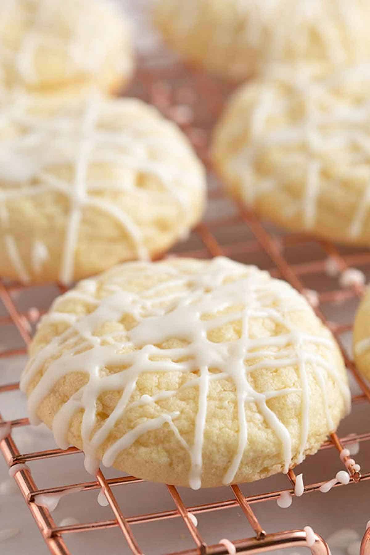 A wire rack with glazed lemon cookies.