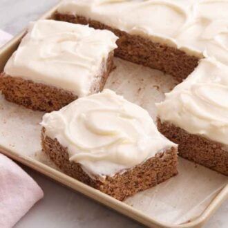 A sheet pan with banana bars, three slices cut.