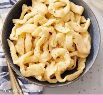 Pinterest graphic of an overhead view of a bowl of cooked egg noodles topped with ground pepper.