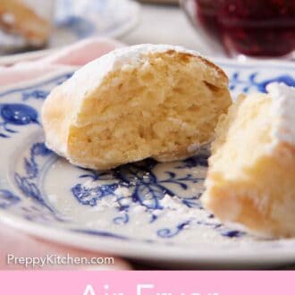 Pinterest graphic of an air fryer beignet cut in half on a plate, showing the interior of the beignet.