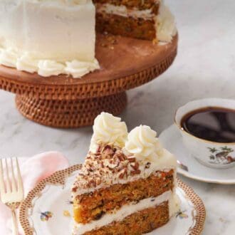 Pinterest graphic of a slice of carrot cake with the rest of the cake on a cake stand in the back along with a cup of coffee.