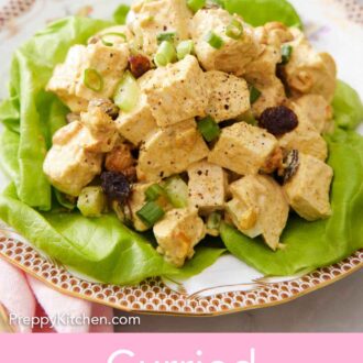 Pinterest graphic of a plate of curried chicken salad over lettuce. A bowl of pepper in the background.