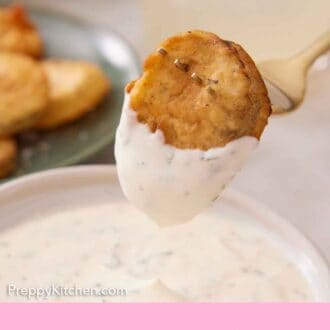 Pinterest graphic of a fork with a fried pickle dripped in sauce.