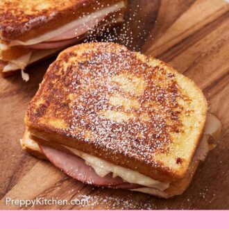 Pinterest graphic of powdered sugar dusted over a Monte Cristo sandwich on a cutting board.
