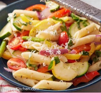 Pinterest graphic of parmesan grated over a bowl of pasta primavera.