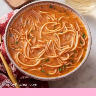 Pinterest graphic of a bowl of sopa de fideo topped with chopped cilantro. Limes and a drink in the background.