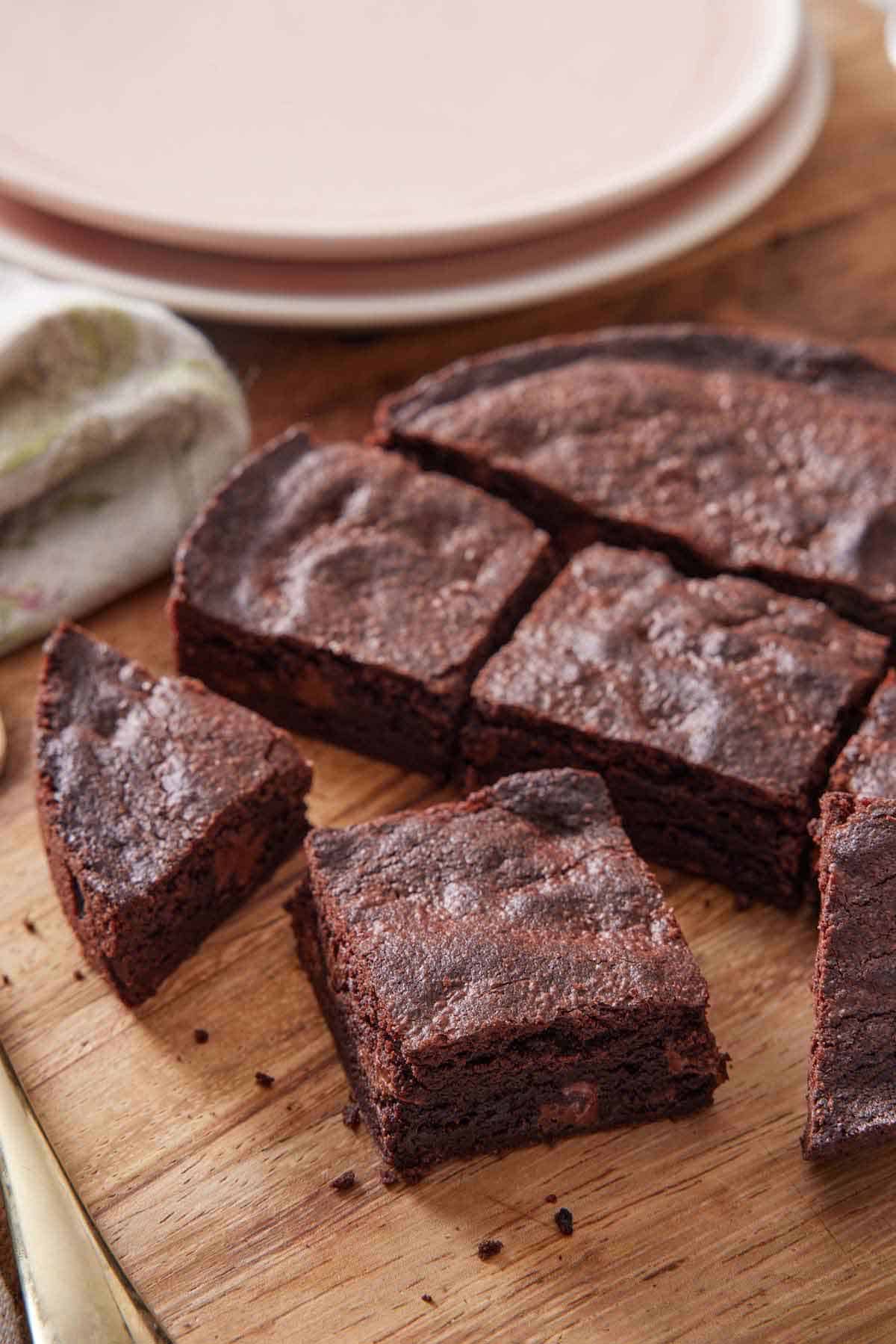 Cut air fryer brownies on a wooden serving board.