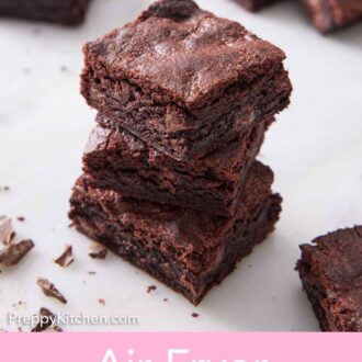 Pinterest graphic of a stack of three air fryer brownies with more brownies in the background.
