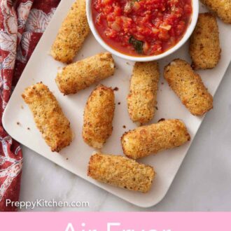 Pinterest graphic of an overhead view of a platter of air fryer mozzarella sticks with a bowl of marinara sauce.