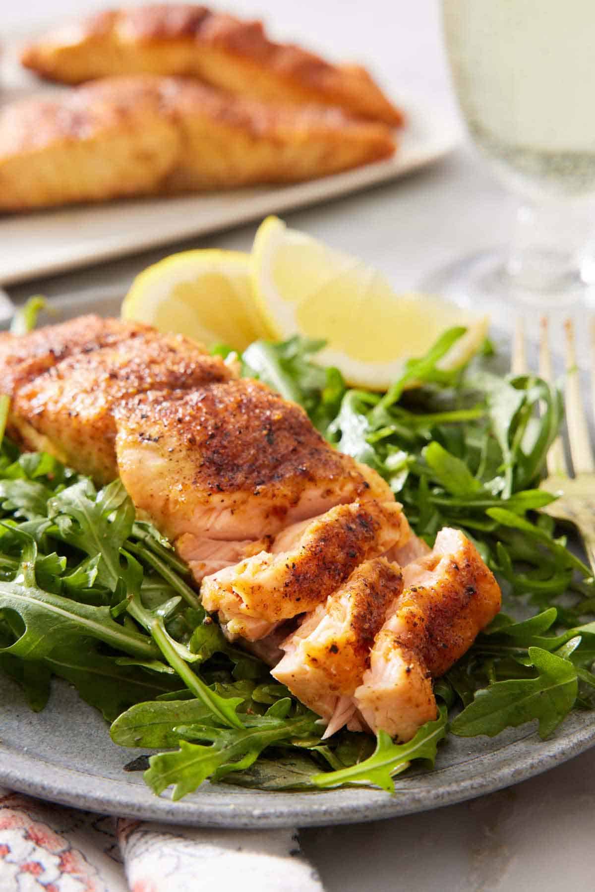 A plate of greens with air fryer salmon on top, flaked.