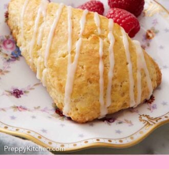 Pinterest graphic of a lemon scone drizzled with icing with fresh raspberries in the back.