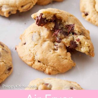 Pinterest graphic of an air fryer cookie torn in half and stacked on top of each other. More cookies surrounding it.