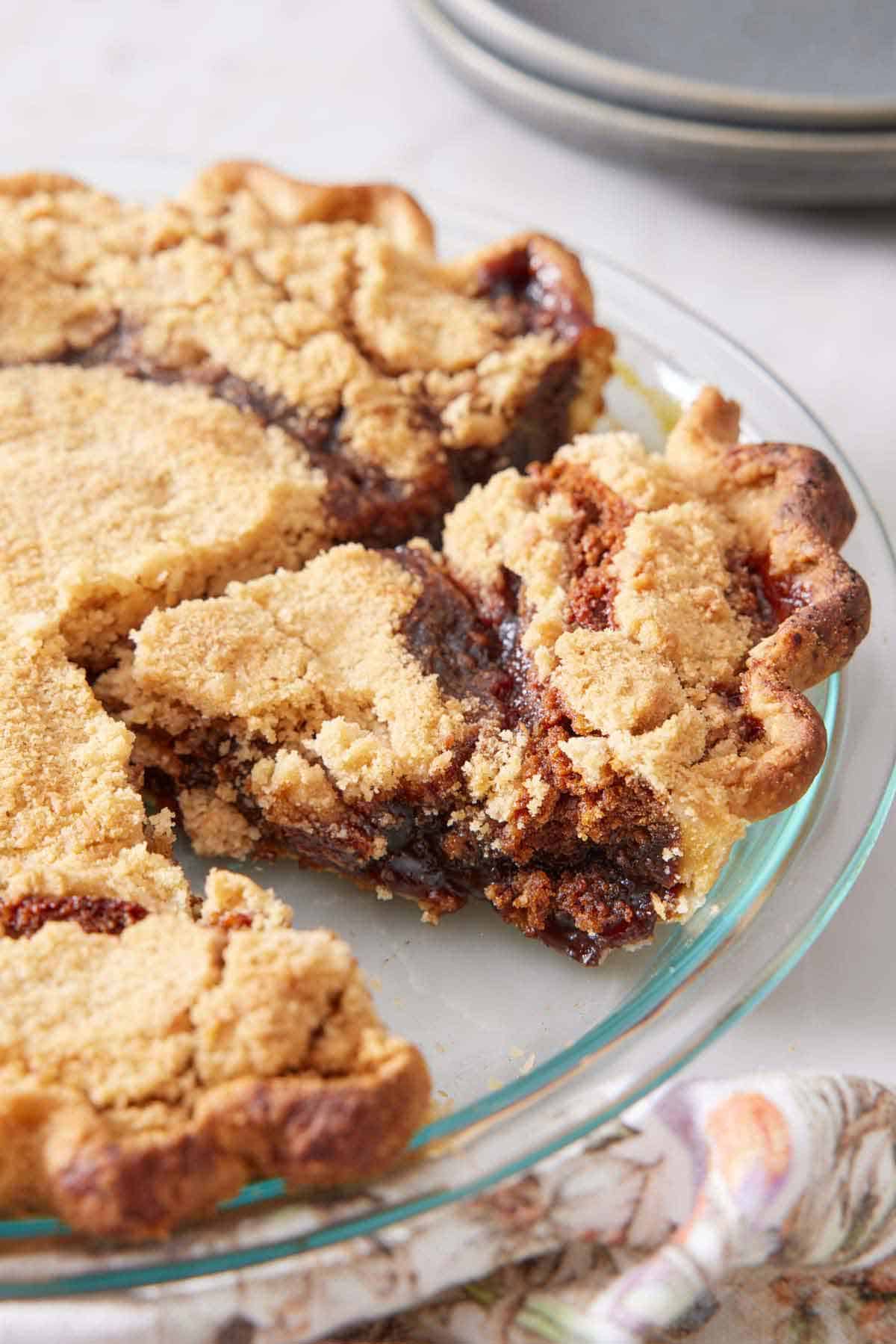 A glass pie dish with a shoofly pie with a slice cut.