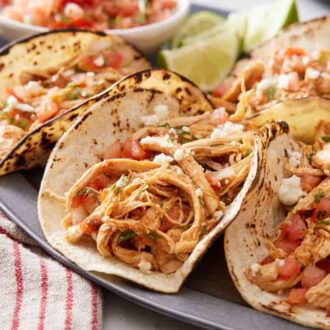Close up view of Instant Pot chicken tacos on a plate.