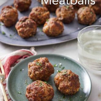 Pinterest graphic of a plate with three air fryer meatballs with more on a platter in the background with a drink in-between.