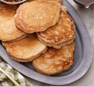 Pinterest graphic of a platter of apple pancakes with a bowl of cooked apples. A bowl of syrup beside it.