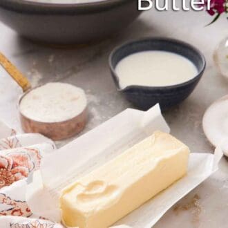 Pinterest graphic of a stick of softened butter in an opened wrapper. A bowl and measuring cup of flour and dairy in the background.