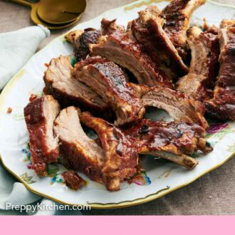 Pinterest graphic of a platter of Instant Pot ribs with a bowl of slaw and barbecue sauce in the background.