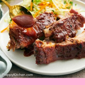Pinterest graphic of a spoonful of barbecue sauce drizzled over Instant Pot ribs on a plate.