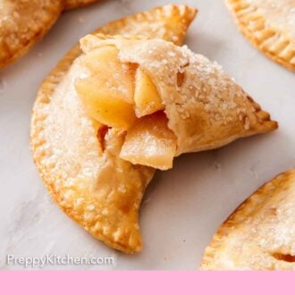 Pinterest graphic of apple pie filling shown inside a cut handheld pie.