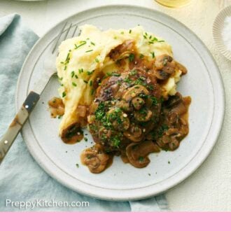 Pinterest graphic of a plate with mashed potatoes and salisbury steak with a fork.
