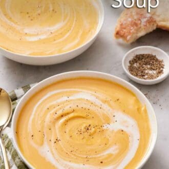 Pinterest graphic of two bowls of sweet potato soup with cream swirled in and topped with pepper.