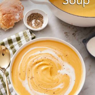 Pinterest graphic of a bowl of sweet potato soup with cream swirled in topped with black pepper.