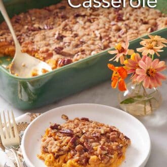 Pinterest graphic of a plate with a serving of sweet potato casserole with flowers in the background along with the rest of the casserole.