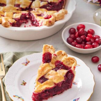 Pinterest graphic of a slice of cranberry pie on a plate with a bowl of fresh cranberries and the rest of the pie in the back.