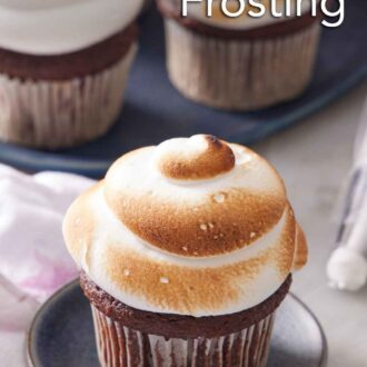 Pinterest graphic of a cupcake topped with fluffy toasted marshmallow frosting with more in the background.
