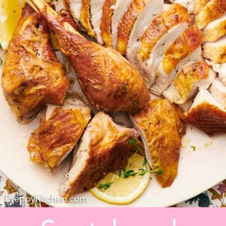 Pinterest graphic of a close up view of a sliced spatchcock turkey with cut lemons and fresh herbs.
