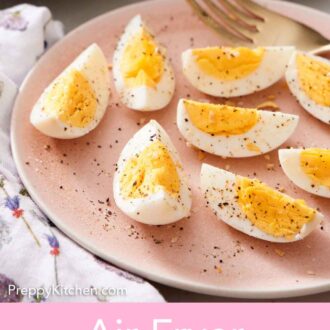 Pinterest graphic of a close up view of a plate of quartered air fryer hard boiled eggs topped with salt and pepper.