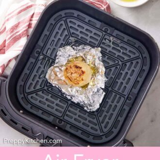 Pinterest graphic of air fryer roasted garlic in foil in the air fryer basket.